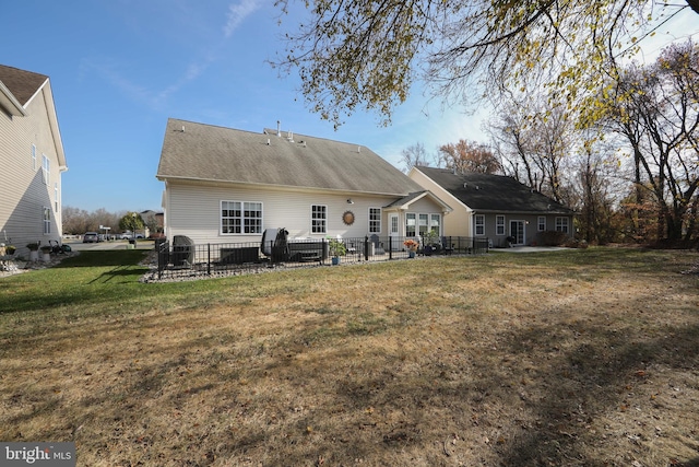 rear view of property featuring a yard