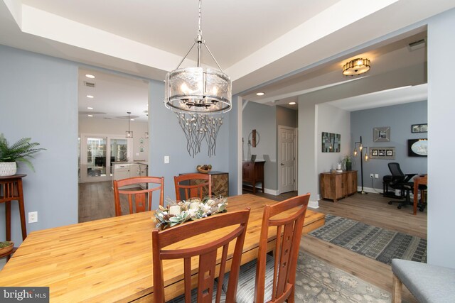 dining area featuring a chandelier and hardwood / wood-style floors