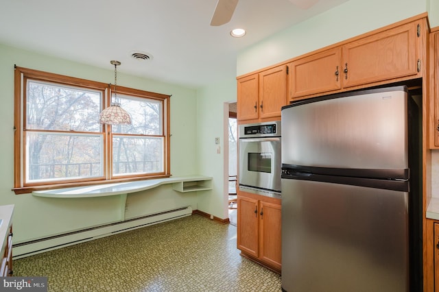 kitchen featuring stainless steel appliances, ceiling fan, pendant lighting, and a baseboard heating unit