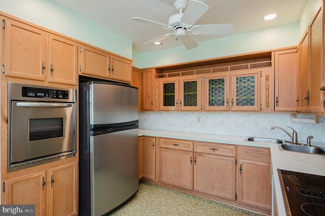 kitchen with stainless steel appliances, ceiling fan, and sink