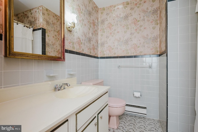 bathroom with tile walls, a baseboard radiator, and vanity