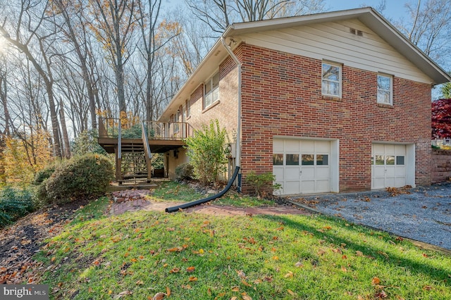 view of side of home featuring a garage and a wooden deck