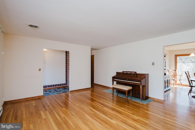 interior space featuring a notable chandelier and light hardwood / wood-style floors