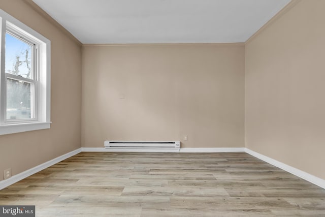 empty room featuring light hardwood / wood-style flooring, a baseboard radiator, and ornamental molding