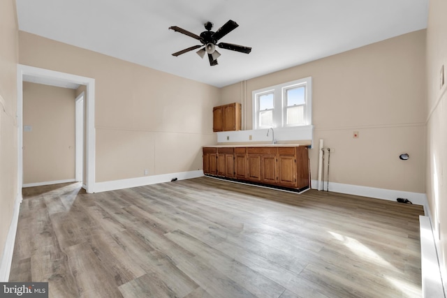 interior space with ceiling fan and light hardwood / wood-style flooring