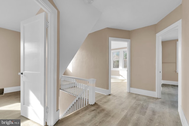 corridor with light hardwood / wood-style flooring