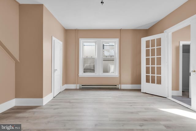 doorway featuring light hardwood / wood-style floors and a baseboard heating unit