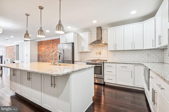 kitchen with white cabinetry, appliances with stainless steel finishes, wall chimney exhaust hood, and dark hardwood / wood-style floors