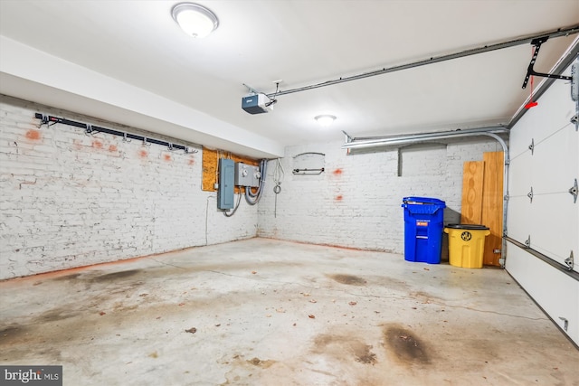 garage with electric panel and a garage door opener