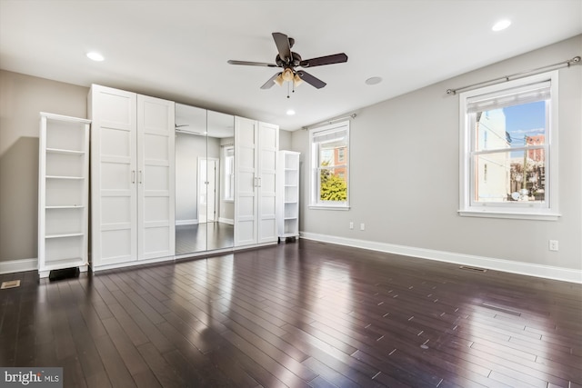 unfurnished bedroom with dark wood-type flooring and ceiling fan