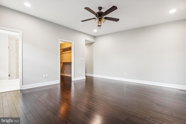 unfurnished room with dark wood-type flooring and ceiling fan