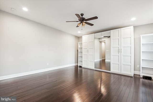 unfurnished bedroom with dark hardwood / wood-style flooring and ceiling fan