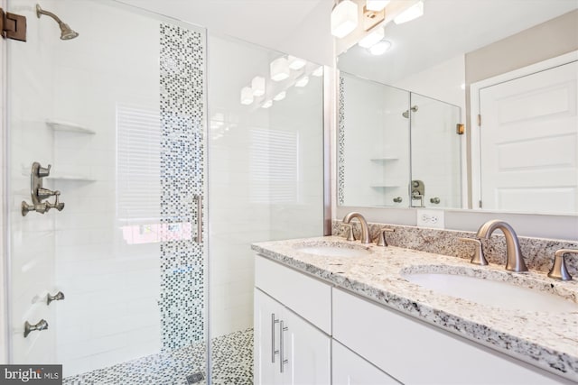 bathroom featuring vanity and a shower with door