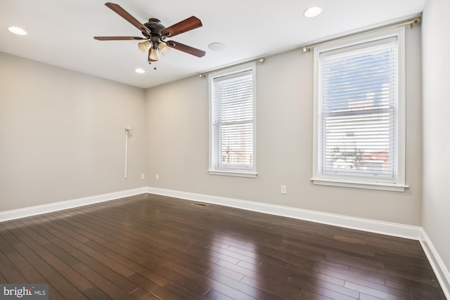 unfurnished room with ceiling fan, a healthy amount of sunlight, and dark hardwood / wood-style floors