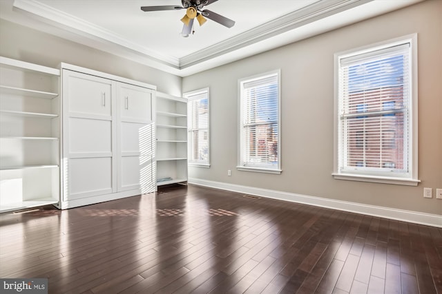 unfurnished bedroom featuring ceiling fan, multiple windows, dark hardwood / wood-style flooring, and ornamental molding