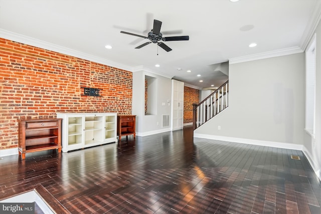 living room with dark wood-type flooring, ceiling fan, brick wall, and crown molding