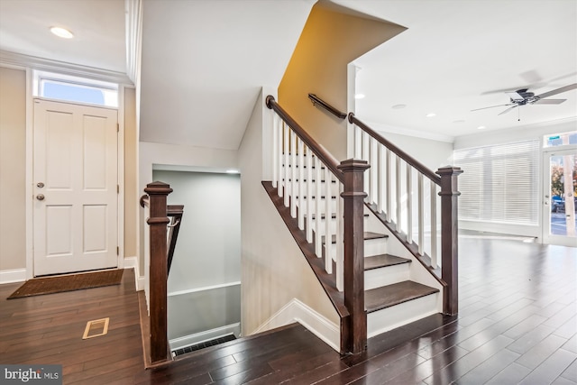 staircase featuring wood-type flooring, plenty of natural light, and ornamental molding