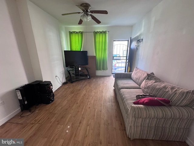 living room with hardwood / wood-style flooring and ceiling fan