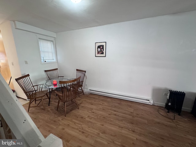 dining room with hardwood / wood-style floors and a baseboard radiator