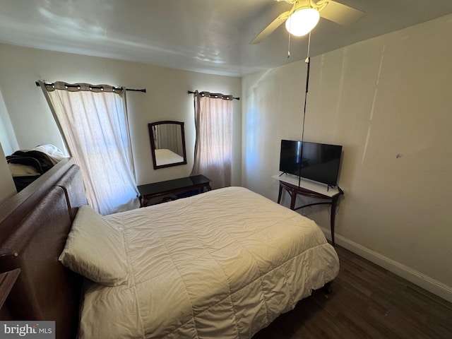 bedroom featuring dark hardwood / wood-style flooring and ceiling fan