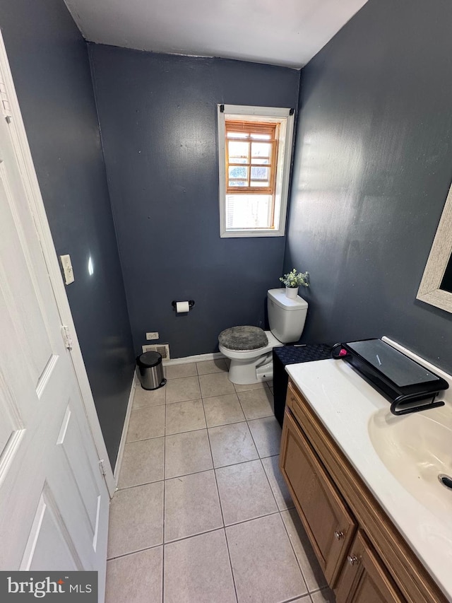 bathroom featuring toilet, vanity, and tile patterned flooring