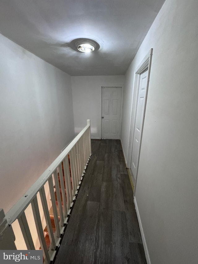 corridor featuring dark hardwood / wood-style flooring