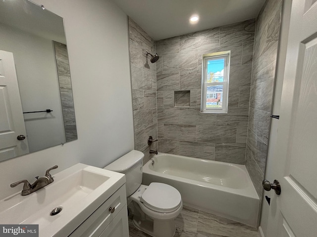 full bathroom featuring vanity, toilet, and tiled shower / bath combo