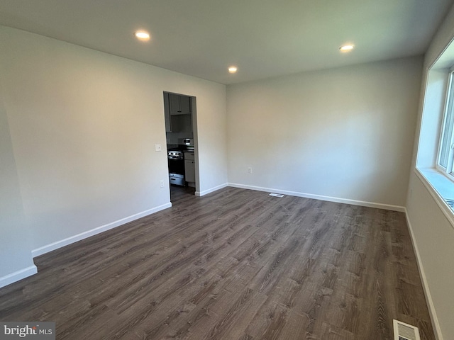 empty room with dark wood-type flooring