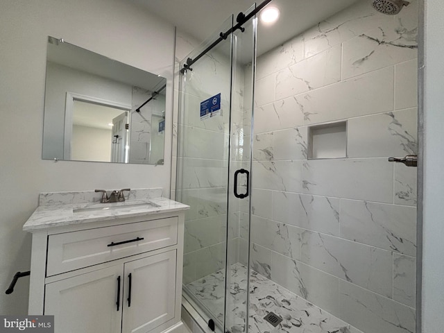 bathroom with walk in shower and vanity