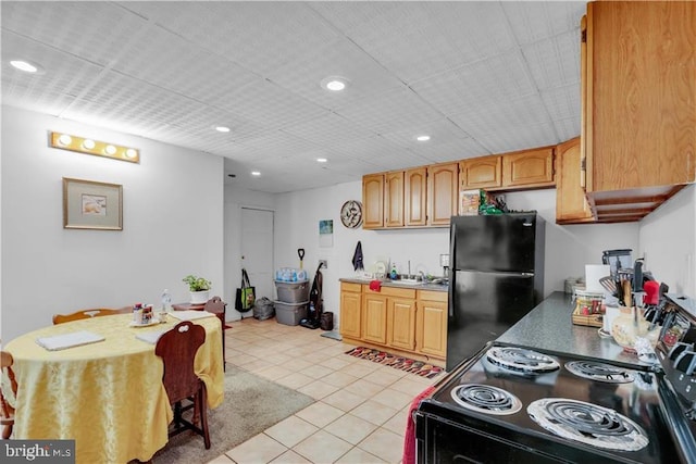 kitchen with sink, light tile patterned floors, and black appliances