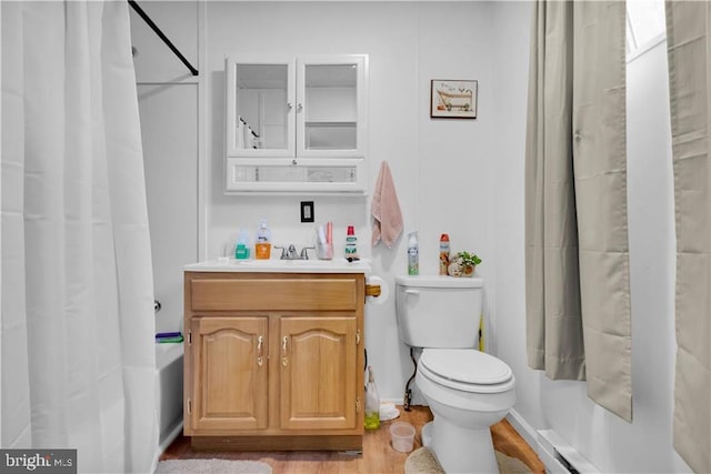 424 E Broad St E, Tamaqua, PA 18252 - full bath with toilet, vanity, shower / tub combo with curtain, baseboard heating, and wood finished floors