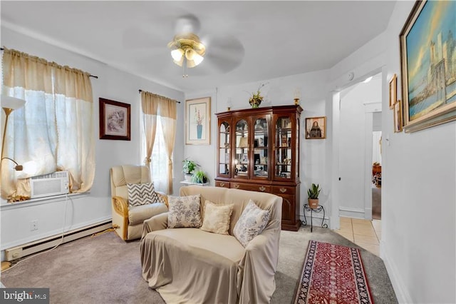 sitting room with ceiling fan, light colored carpet, and a baseboard heating unit