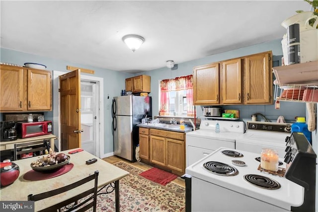 424 E Broad St E, Tamaqua, PA 18252 - kitchen featuring freestanding refrigerator, washing machine and clothes dryer, electric range, light countertops, and light wood-style flooring