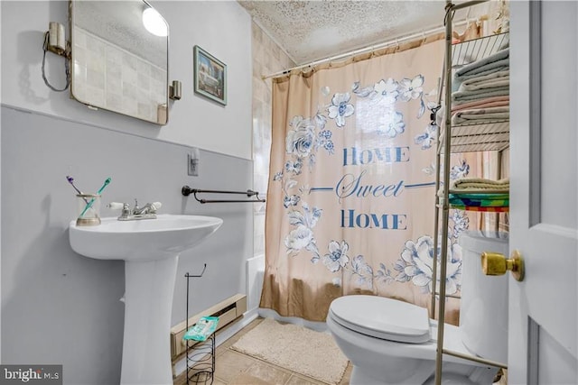 bathroom featuring shower / bath combination with curtain, a textured ceiling, and toilet