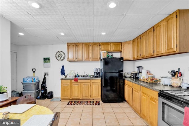 kitchen featuring white electric range oven, black refrigerator, light tile patterned floors, and sink