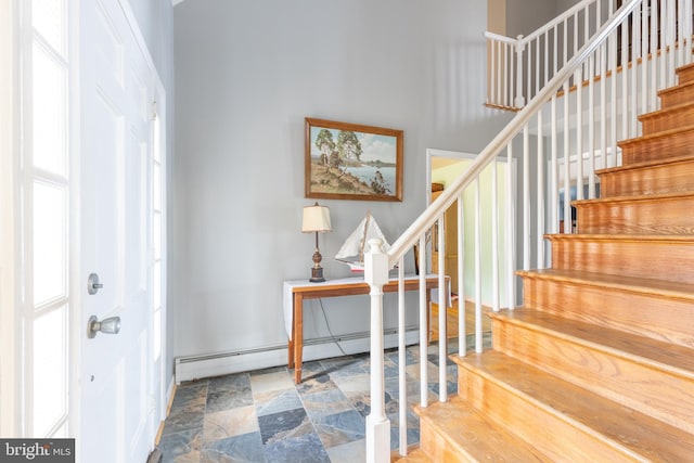 foyer entrance featuring a baseboard heating unit