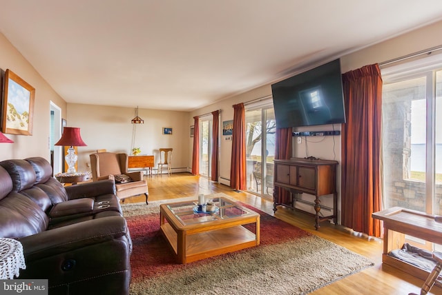 living room featuring baseboard heating and hardwood / wood-style flooring