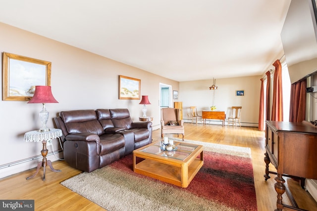 living room with light wood-type flooring and baseboard heating