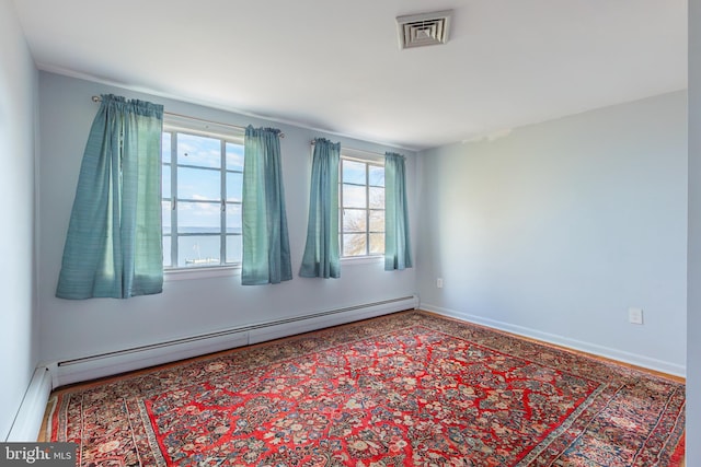 unfurnished room with a baseboard radiator