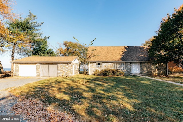 ranch-style home with a front yard and a garage