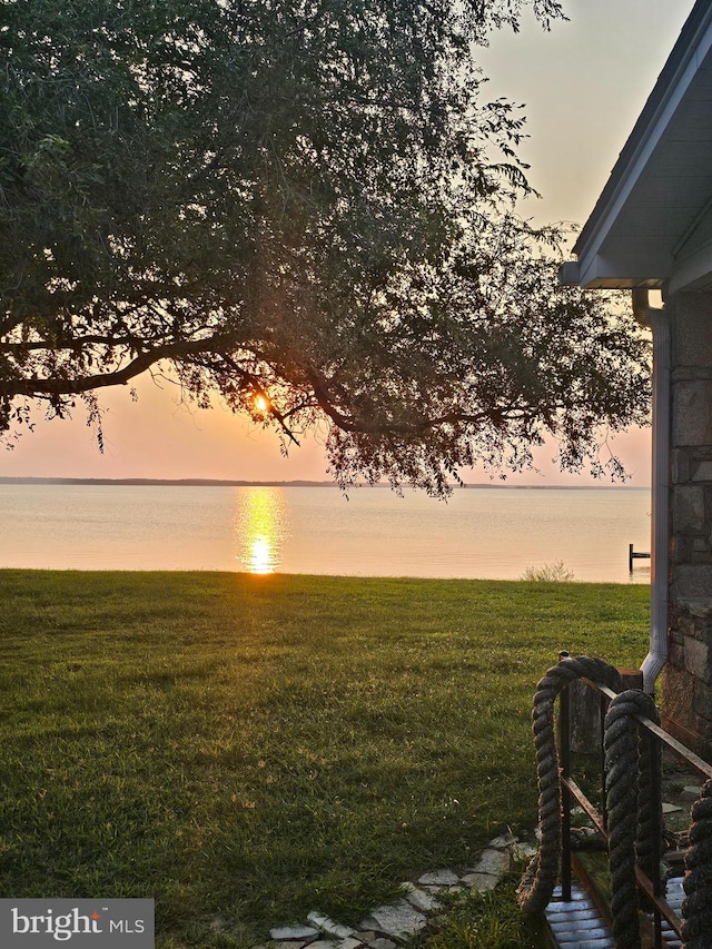 yard at dusk with a water view