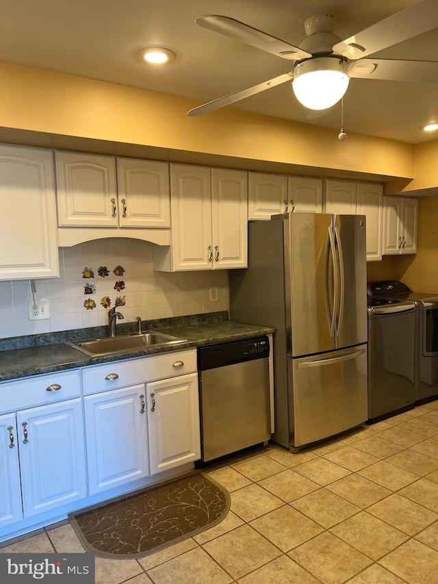 kitchen with white cabinetry, sink, appliances with stainless steel finishes, tasteful backsplash, and washer and dryer