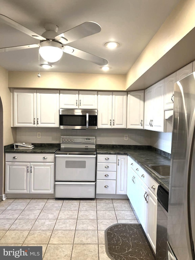 16 Stonehenge Cir Unit 16-5, Pikesville, MD 21208 - kitchen featuring stainless steel appliances, white cabinets, and dark countertops