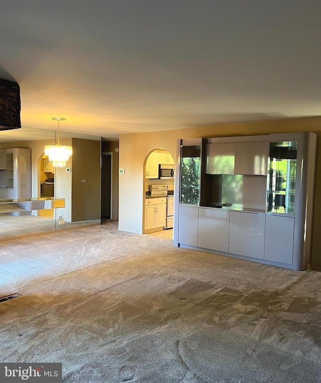 unfurnished living room featuring light colored carpet