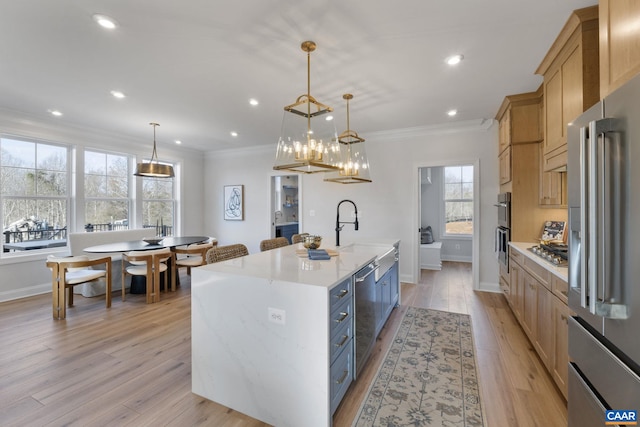 kitchen featuring hanging light fixtures, a wealth of natural light, a spacious island, and appliances with stainless steel finishes