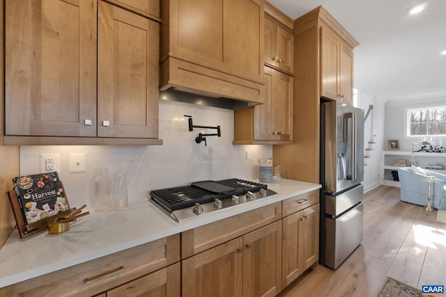 kitchen with stainless steel appliances and light hardwood / wood-style floors