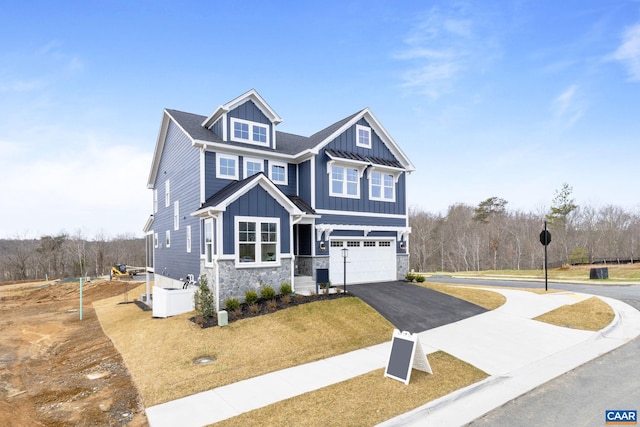 craftsman-style home with a garage and a front yard