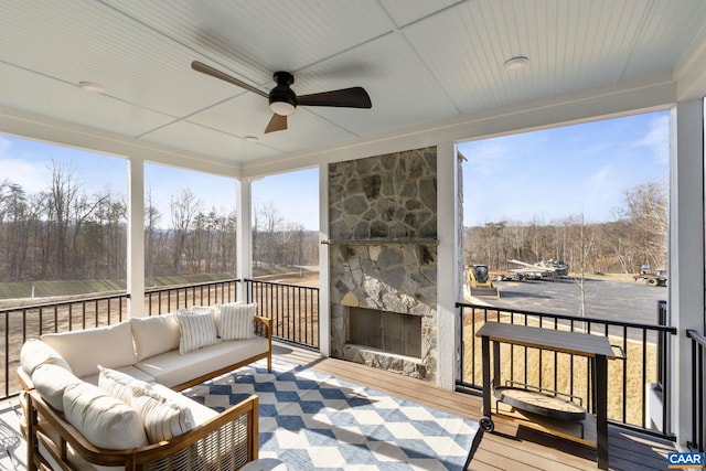 sunroom / solarium featuring ceiling fan