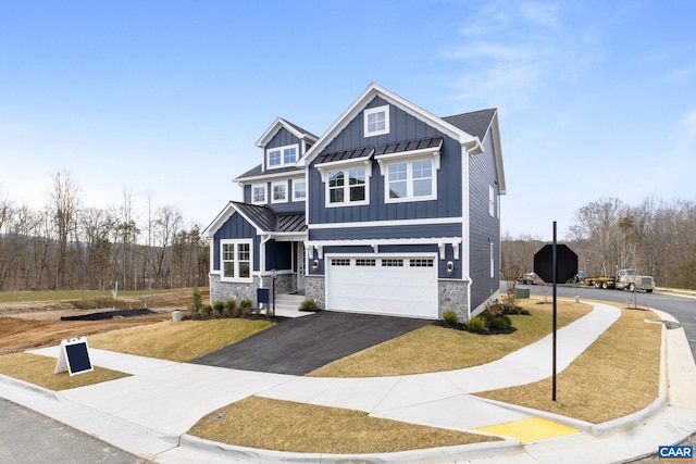 craftsman house with a garage and a front lawn