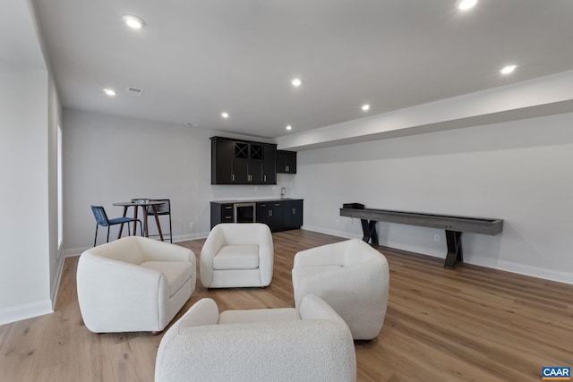 living room featuring bar area and dark hardwood / wood-style floors